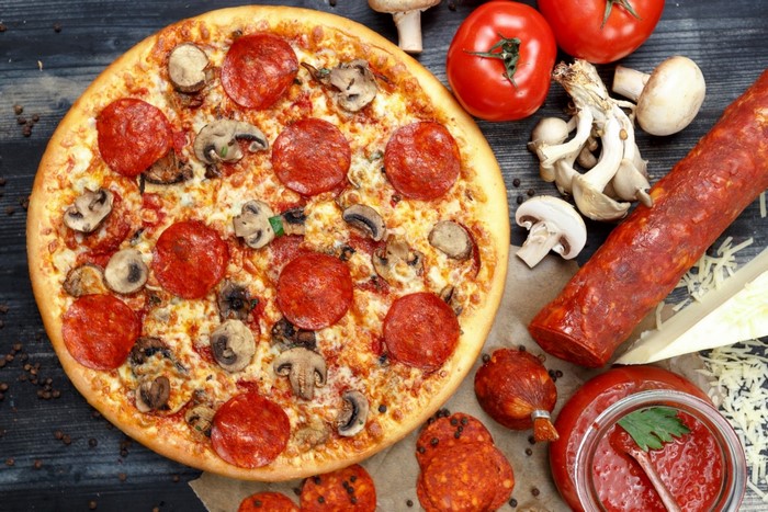 Pepperoni and mushroom pizza with ingredients