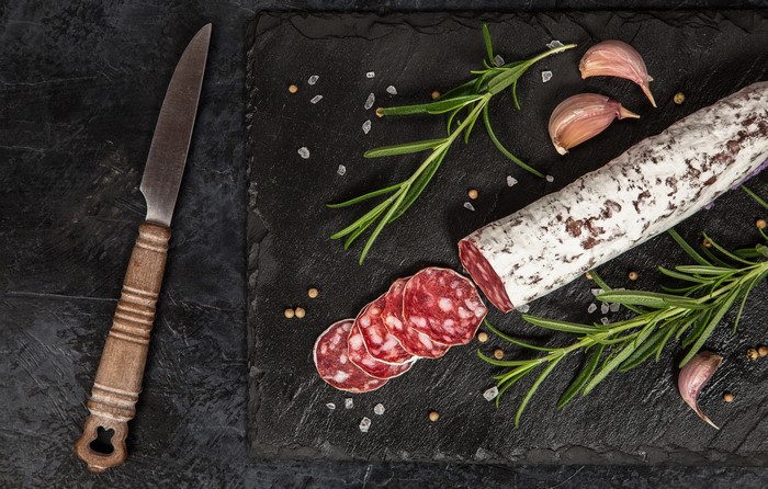 Salami, Garlic, Rosemary, and Knife on Slate