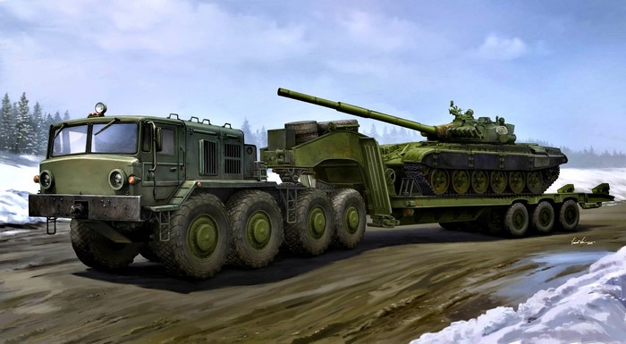 Military truck transporting a tank in a snowy landscape