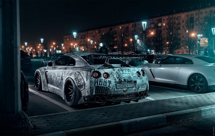 Nissan GT-R with custom artwork parked at night