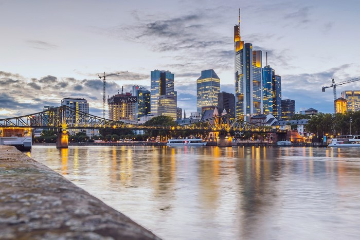 Frankfurt cityscape with bridge and river at dusk