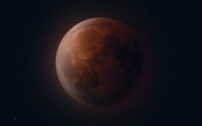 Blood moon in space with stars