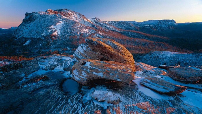Snow-covered mountains and rocks at sunrise in Tasmania