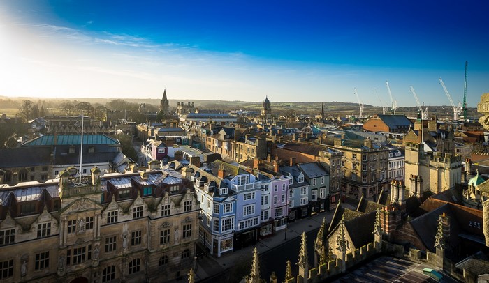 Panoramic cityscape of Oxford with cranes in the distance