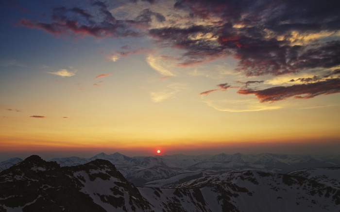 Sunset over snow-capped mountains