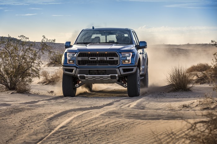 Blue Ford F-150 Raptor driving in desert