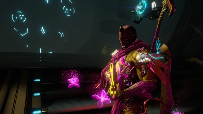 Warframe character with pink and yellow armor and staff