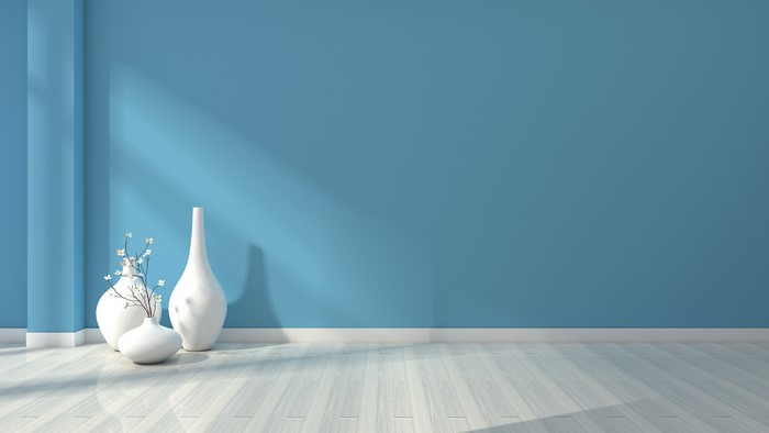 Minimalist interior with blue wall and vases