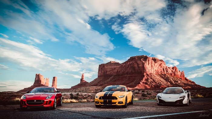 Jaguar, Ford Mustang, and McLaren cars in Monument Valley