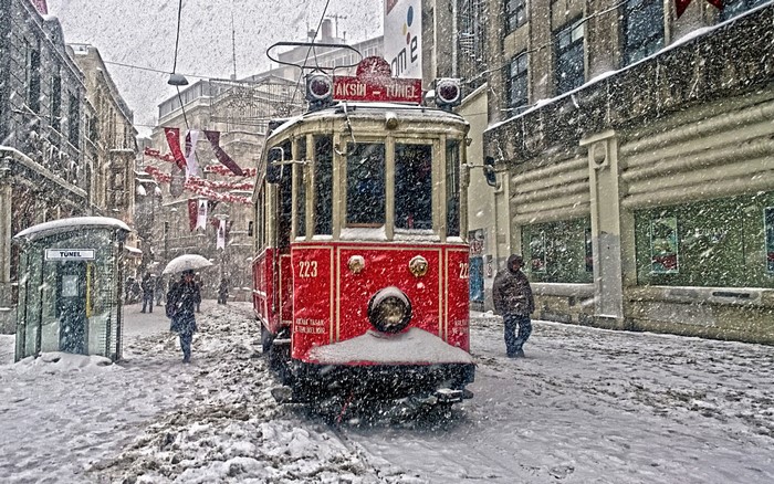 Red tram in Istanbul during a snowstorm
