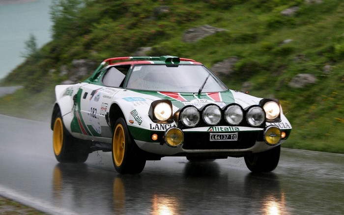 Lancia Stratos rally car with Alitalia livery on wet road