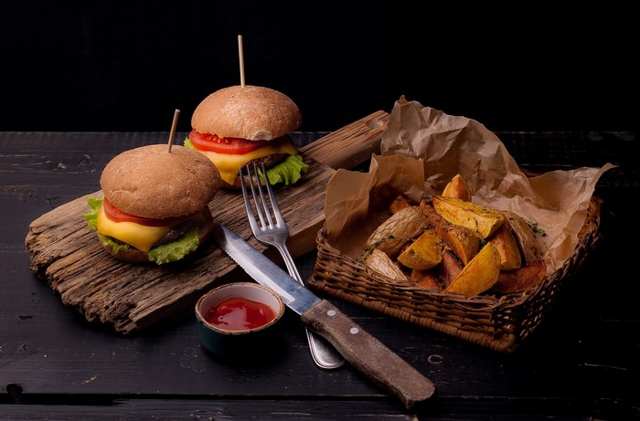 Two burgers with fries and ketchup