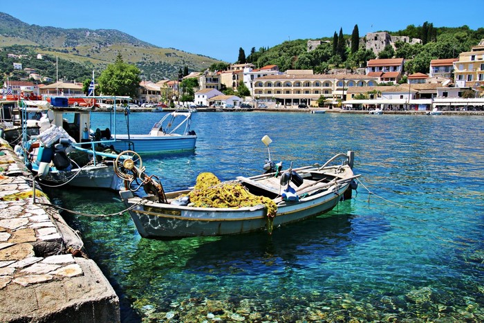 Boats docked in a clear blue bay in Greece