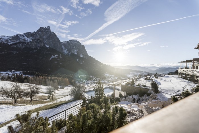 Winter landscape with mountains and sun