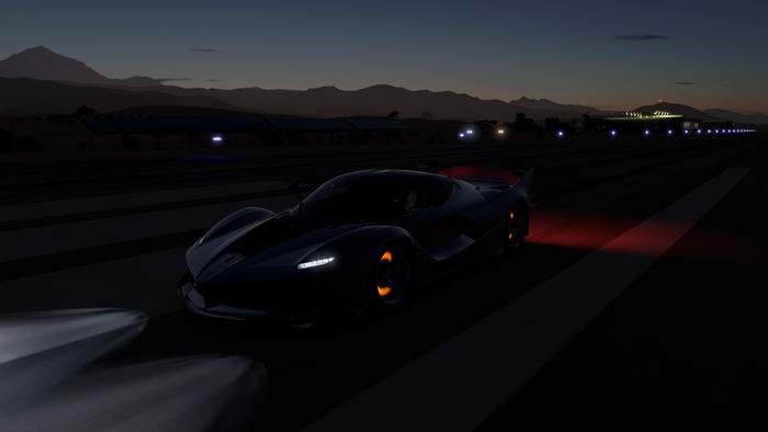 Ferrari FXX K on a runway at dusk
