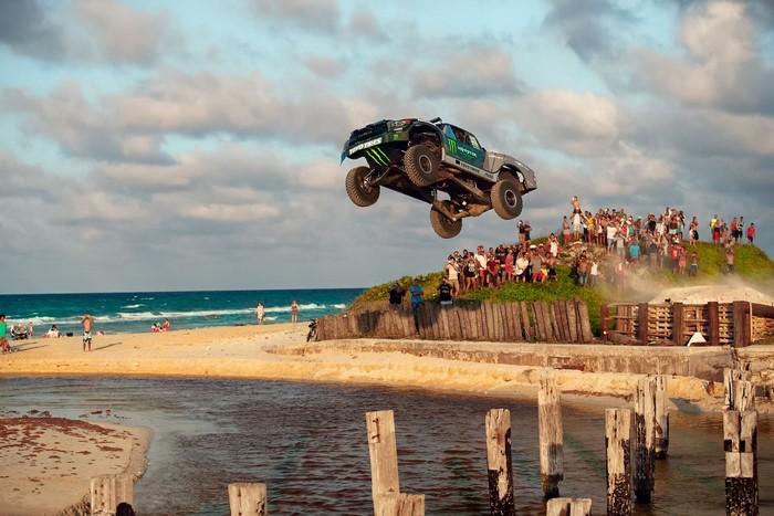 Monster Energy Offroad Truck Jumping Over Water at Beach