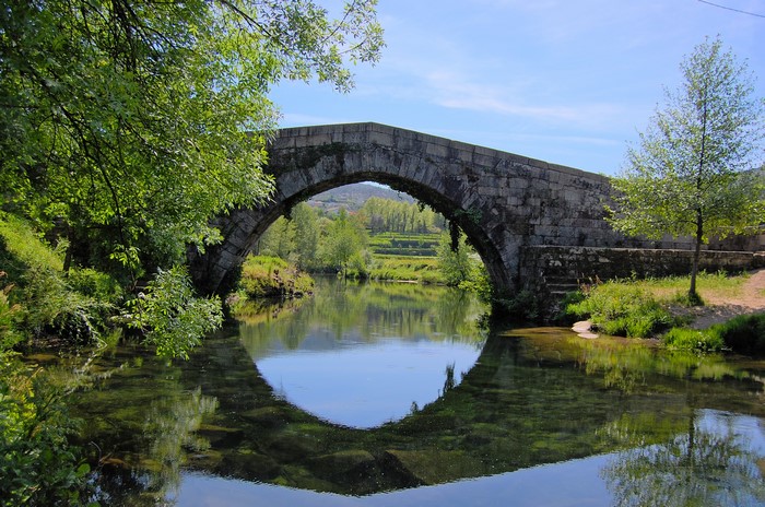 Stone bridge over a river with reflections