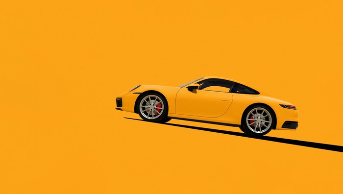 Yellow Porsche 992 on a yellow background