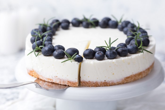 Blueberry cheesecake with rosemary on a cake stand