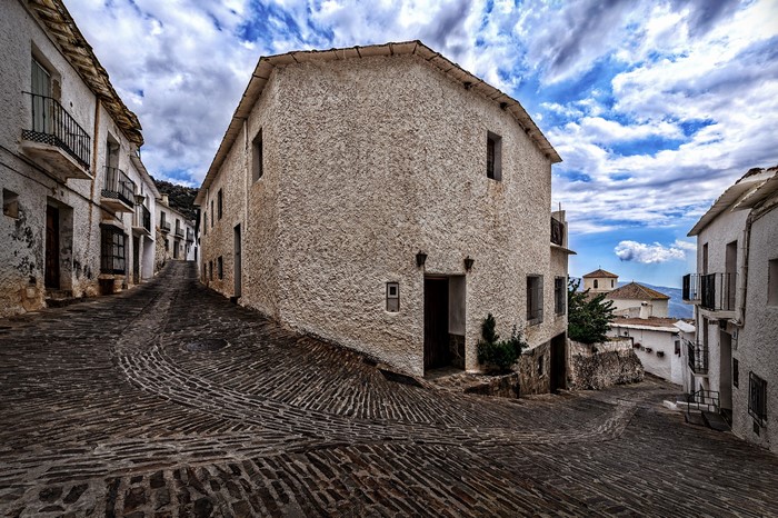 Old cobblestone street in a white village