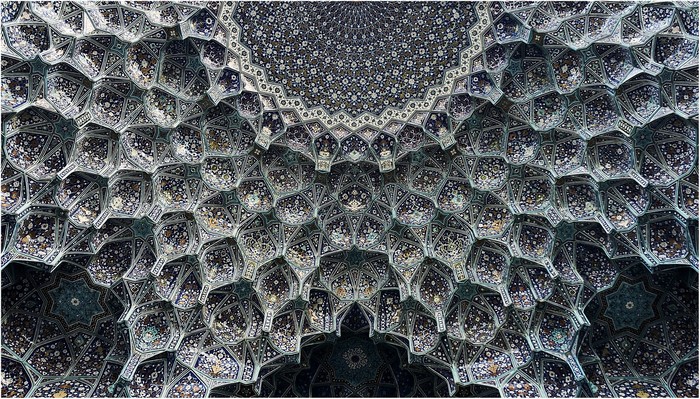 Intricate Islamic geometric tile patterns on a dome in Iran