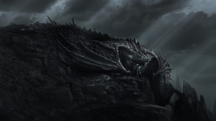 Dark dragon with green eyes on rocky terrain