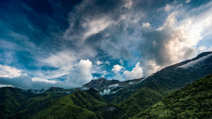 Dramatic sky over green mountains