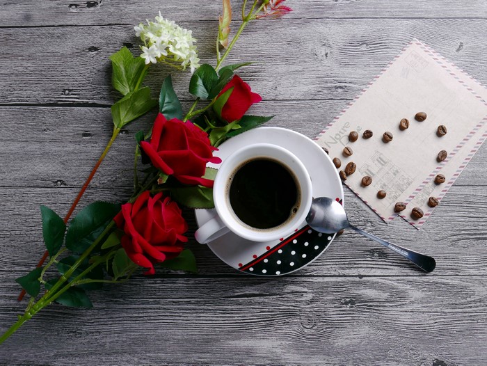 Coffee cup with roses and coffee beans