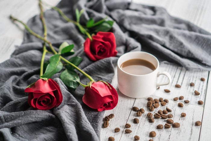 Red roses and coffee with beans