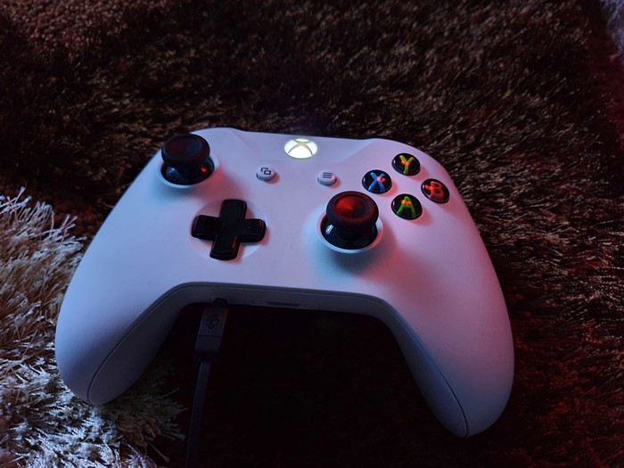 Xbox One controller on a brown background