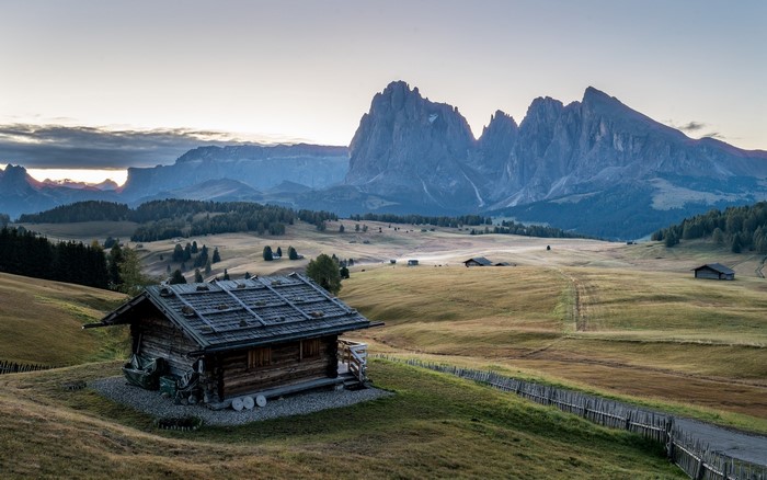 Wooden hut in a mountain landscape at sunrise