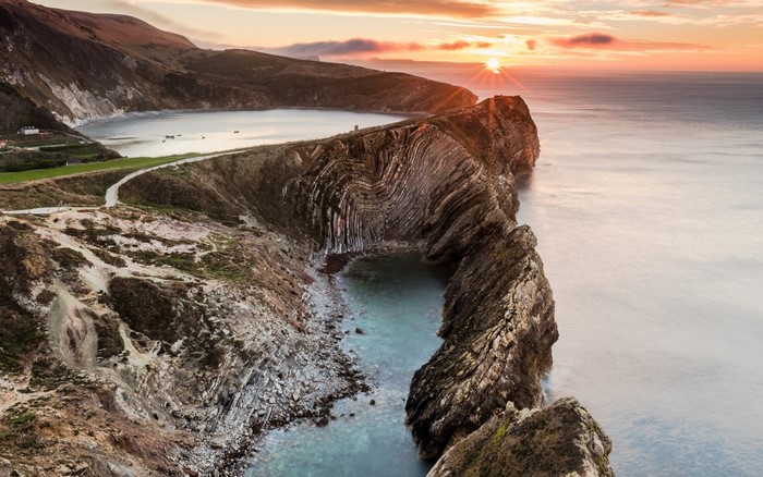 Coastal cliffs and bay at sunset