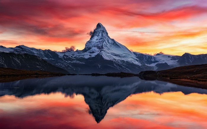 Matterhorn mountain reflected in a lake at sunset