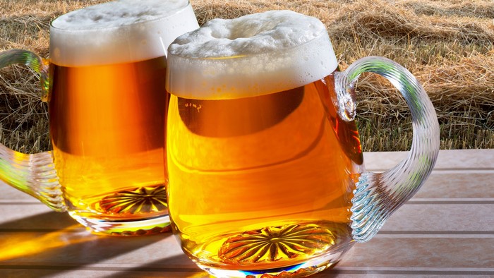 Two glasses of beer with foam