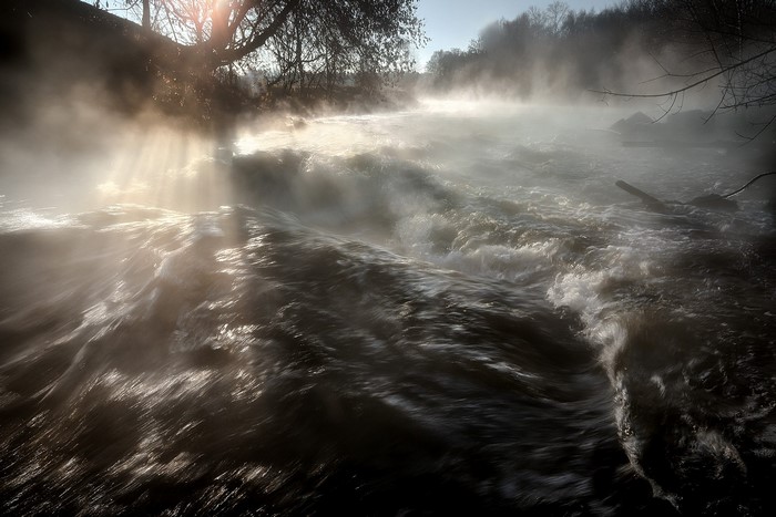 Misty river with sunbeams
