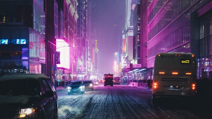 Snowy night in New York City with neon lights