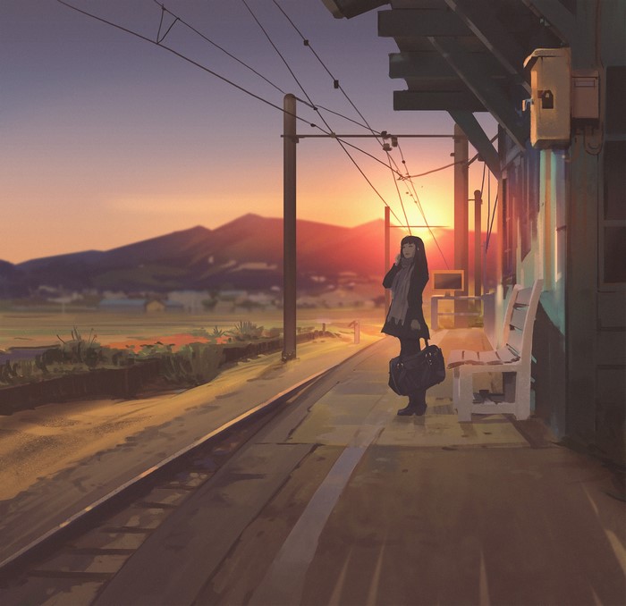 Woman on train station platform at sunset