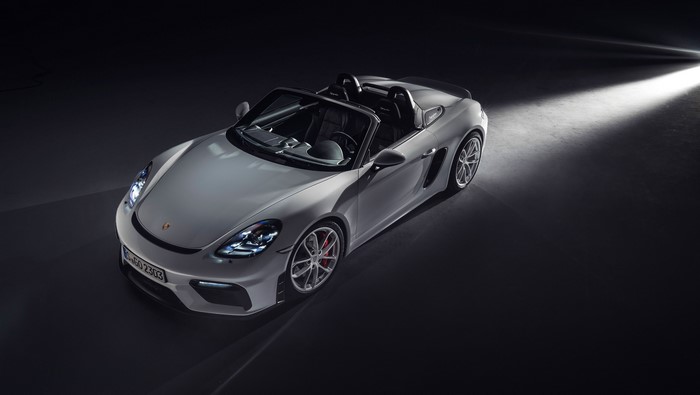 Porsche 718 Spyder sports car with headlights on