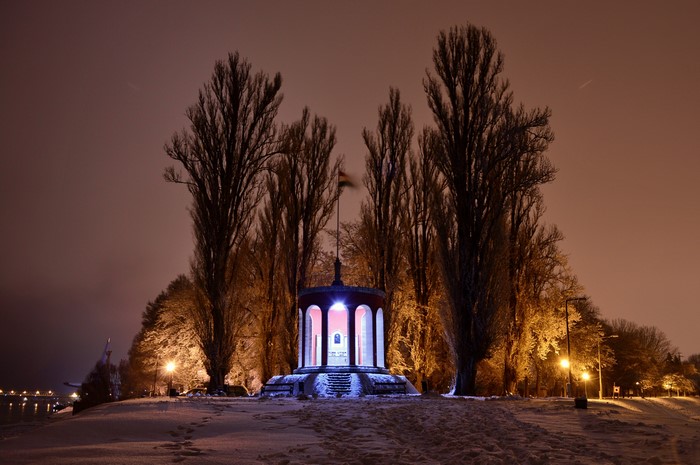 Winter night in Hungary with snow and a monument
