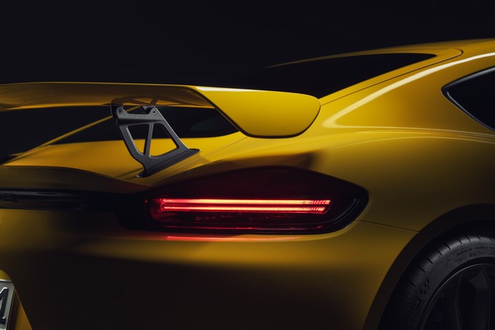 Yellow Porsche 718 Cayman taillight and spoiler