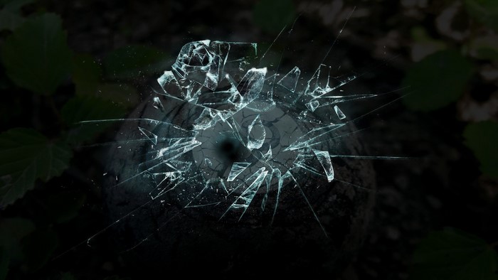 Broken glass over a dark surface