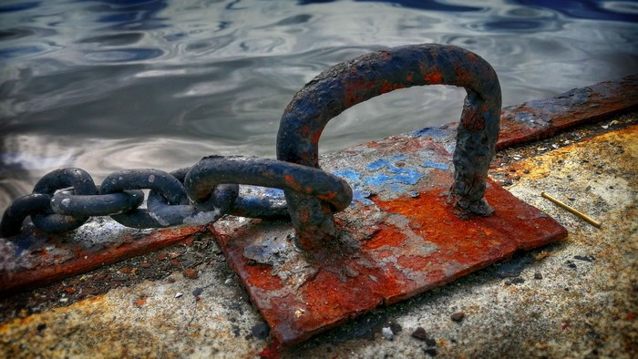 Rusty chain and mooring on a dock