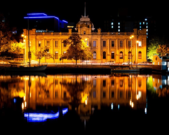 Old building reflected in water at night