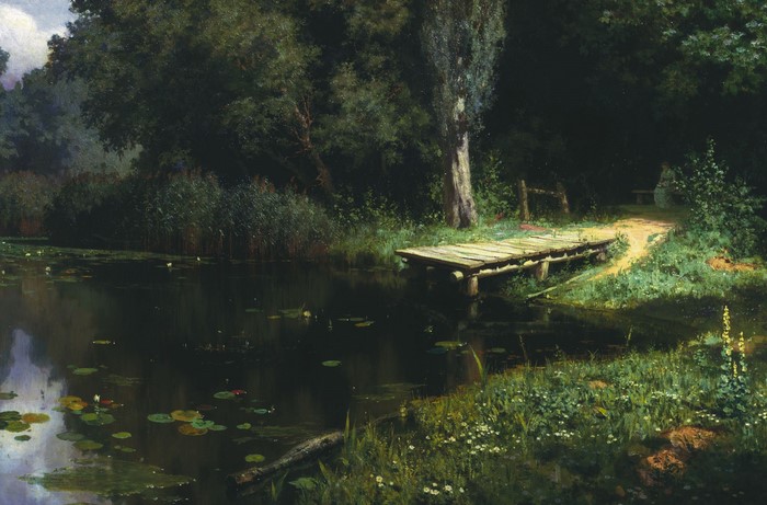 A wooden dock on a dark lake surrounded by trees