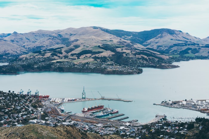 Port city nestled in a bay with mountains