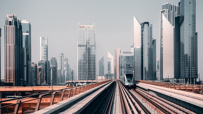 Dubai cityscape with a modern train on elevated tracks
