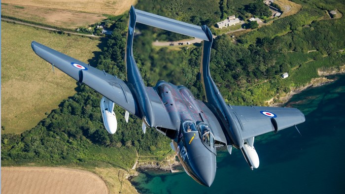 De Havilland Sea Vixen military aircraft flying over coast