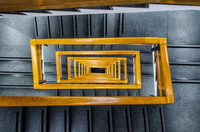 Yellow handrails on a spiral staircase