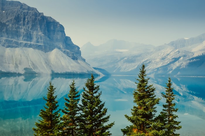 4K trees and mountains reflected in water