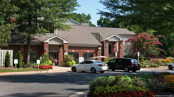 Apartment building with cars and landscaping